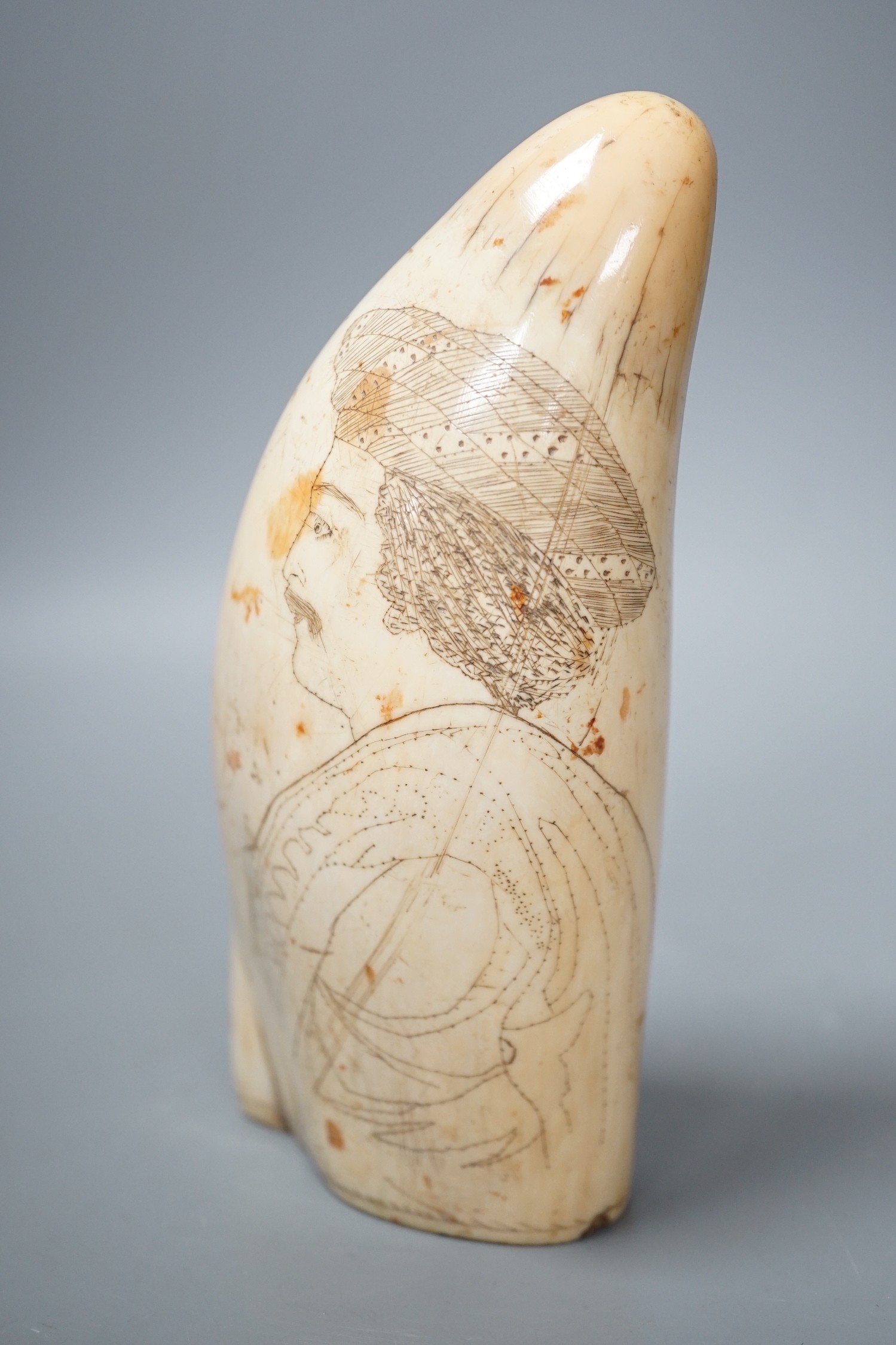 A 19th century scrimshaw whale tooth, 16cm